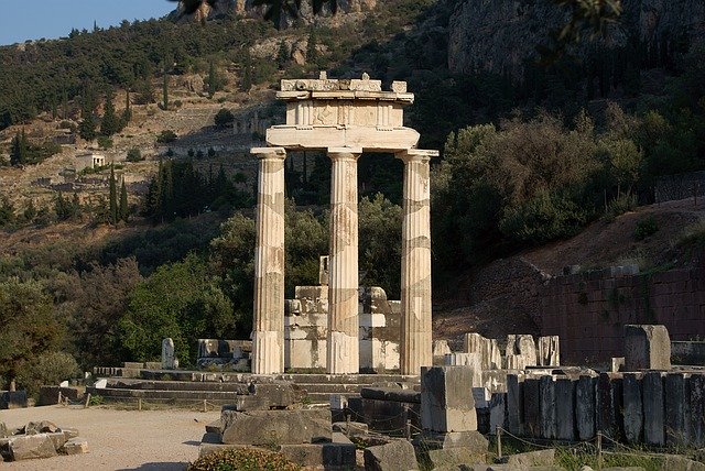 A large stone structure with pillars in the middle of it.