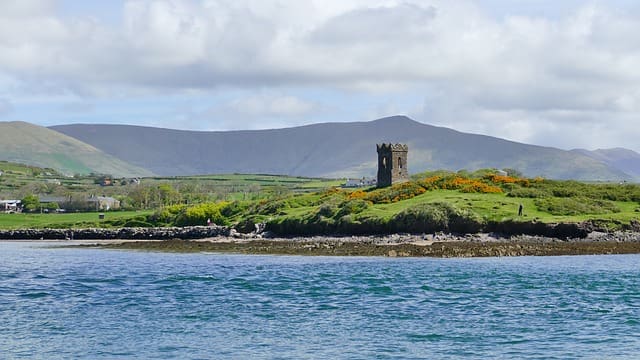 A small tower on the side of a hill