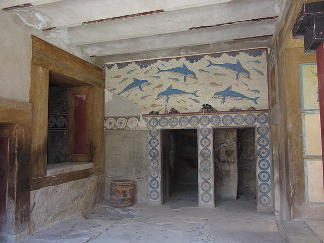 A room with a wall painting and two doors.