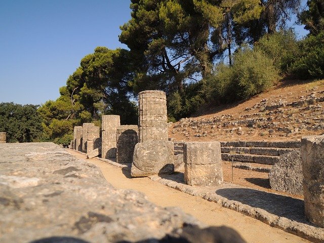 A stone wall with pillars and steps in the background.