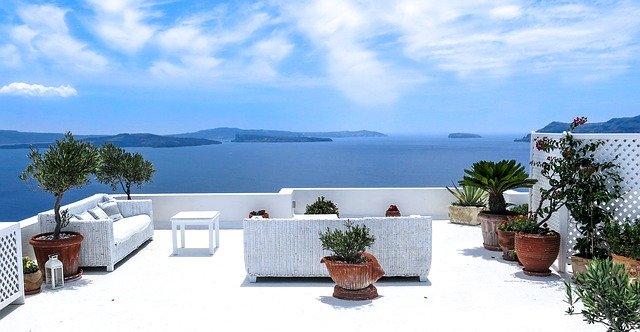 A white couch sitting on top of a patio.
