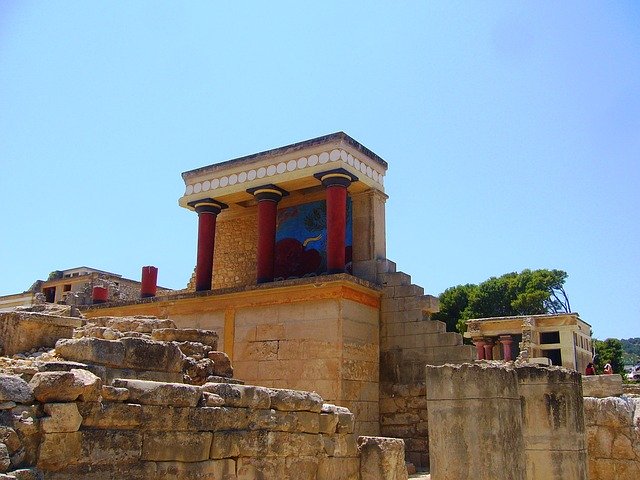 A stone structure with red trim and pillars.