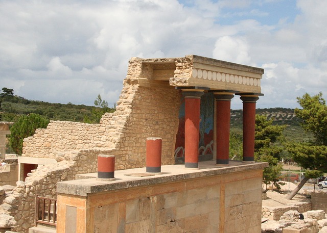 A stone structure with columns and pillars on top of it.