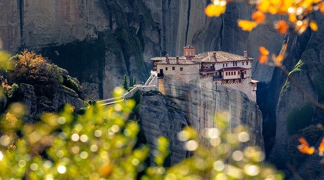 A view of the side of a cliff with a building on it.