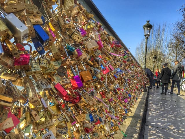 A wall covered in locks of different colors.