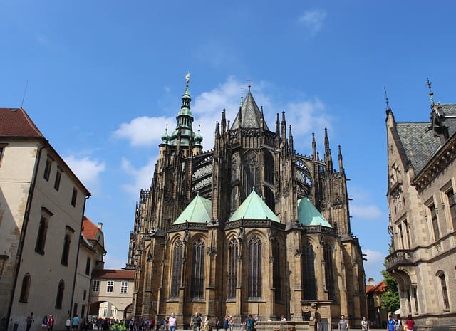 A cathedral with many spires and windows on the side of it.