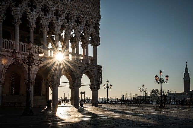 A sun setting over the water in venice.