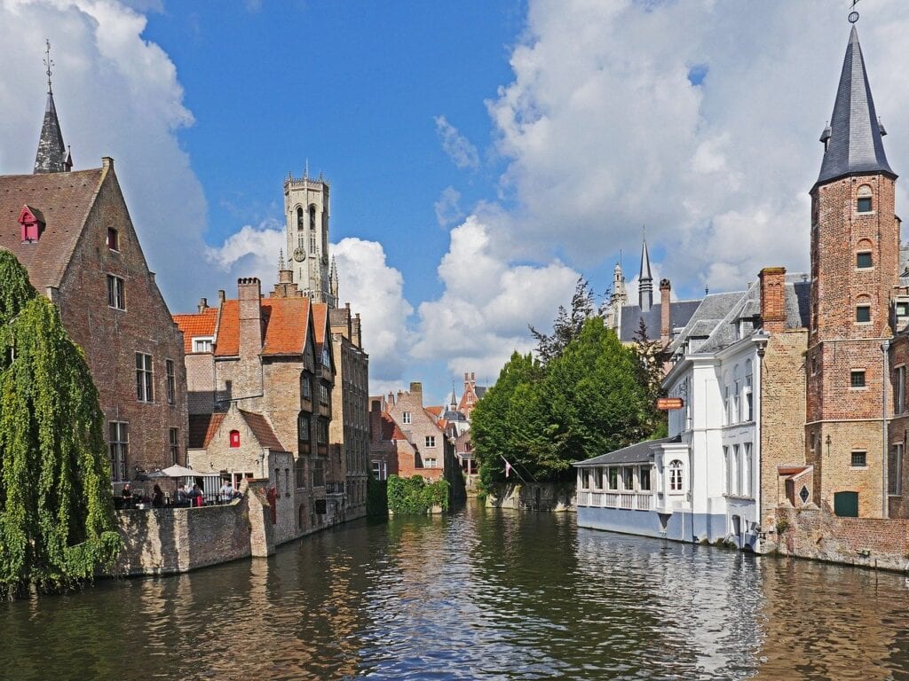 A canal with buildings and trees in the background.