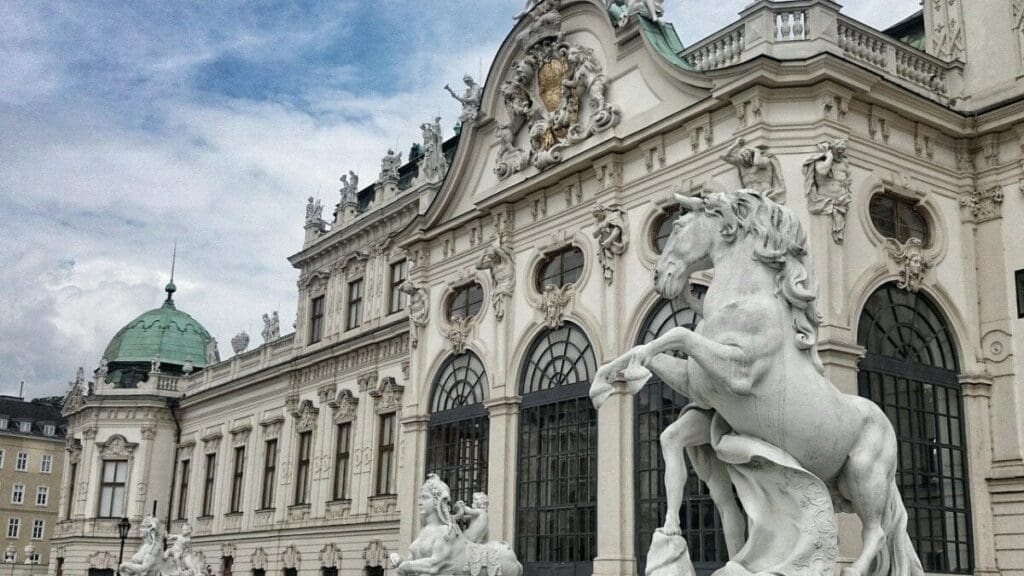 A large building with statues in front of it