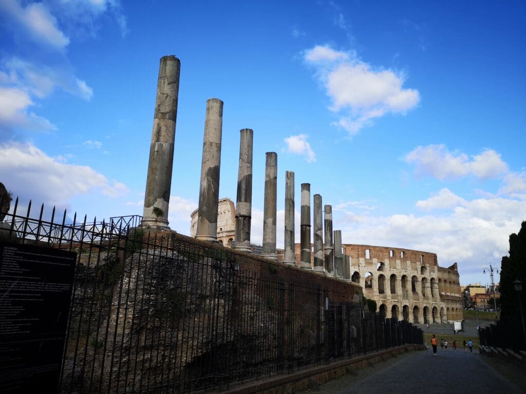 A row of tall pillars on top of a wall.