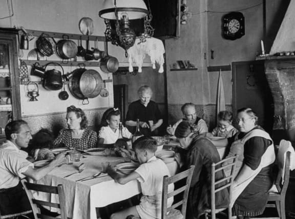 A group of people sitting around a table.