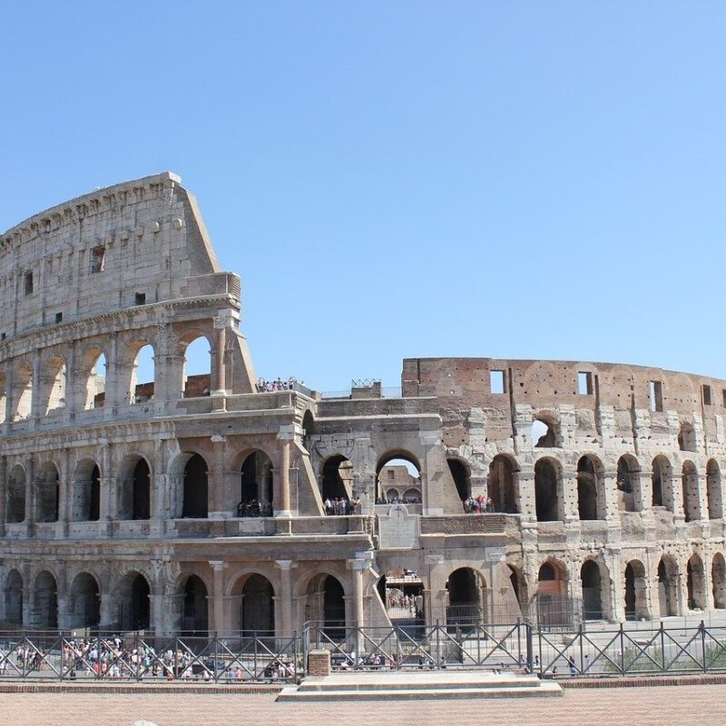 A large roman colosseum with many windows and arches.