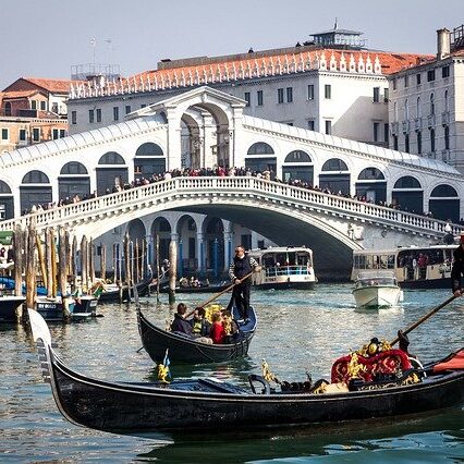 A group of people riding on the back of boats.